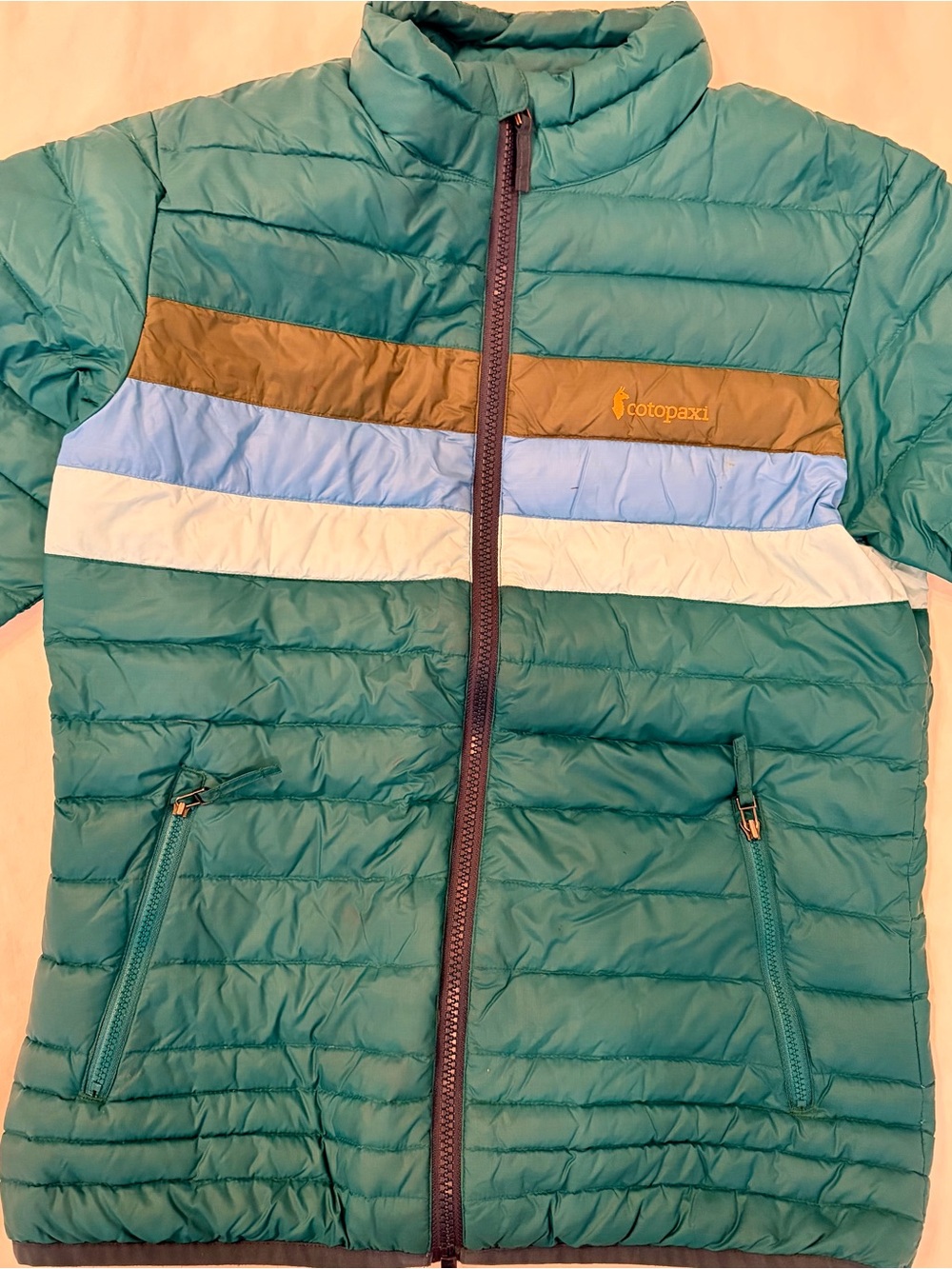 Cotopaxi Green Puffer Jacket with Olive, Blue & Light Green Stripes. Youth Large